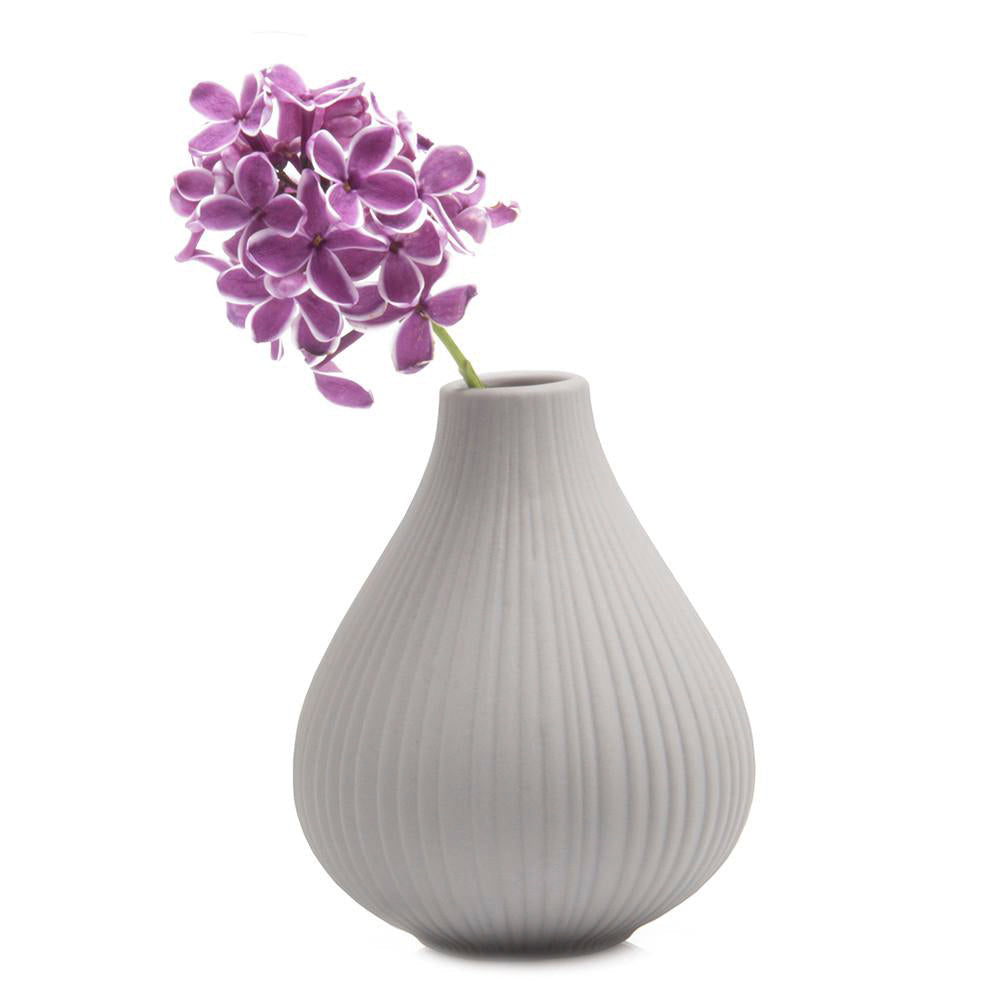 A single purple hydrangea flower in a Frost Porcelain Bud Vase For Flowers by Chive Studio 2024, against a white background.