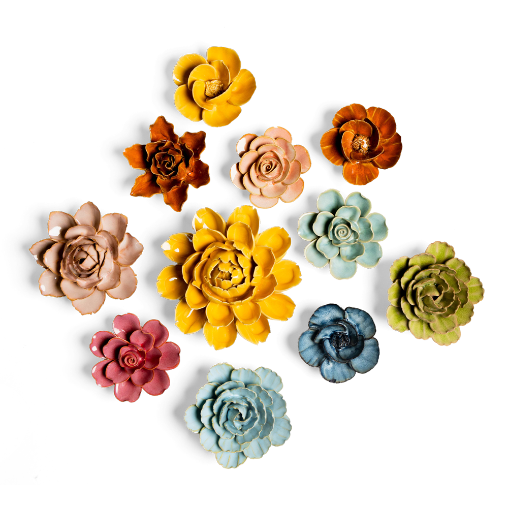 A vibrant collection of ceramic flowers arranged on a black background, featuring various colors like yellow, pink, blue, green, orange, and brown, each with intricate petal details.