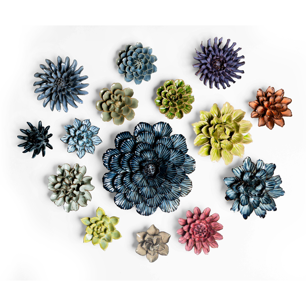 A collection of colorful ceramic flowers in various sizes and colors including blue, green, purple, pink, and yellow, arranged on a black background.