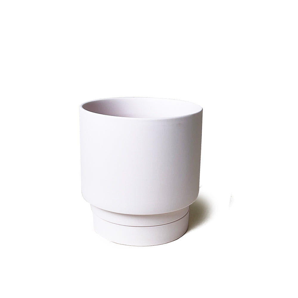 A simple white ceramic Chive Studio 2024 Casey Porcelain Modern Pot And Saucer Set with a smooth finish and a detached saucer, isolated on a white background.