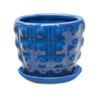 A vibrant blue Convex Ceramic Pot with Drainage Hole and Saucer by Chive Studio 2024, with a decorative Dalek embossed pattern, all isolated on a white background.