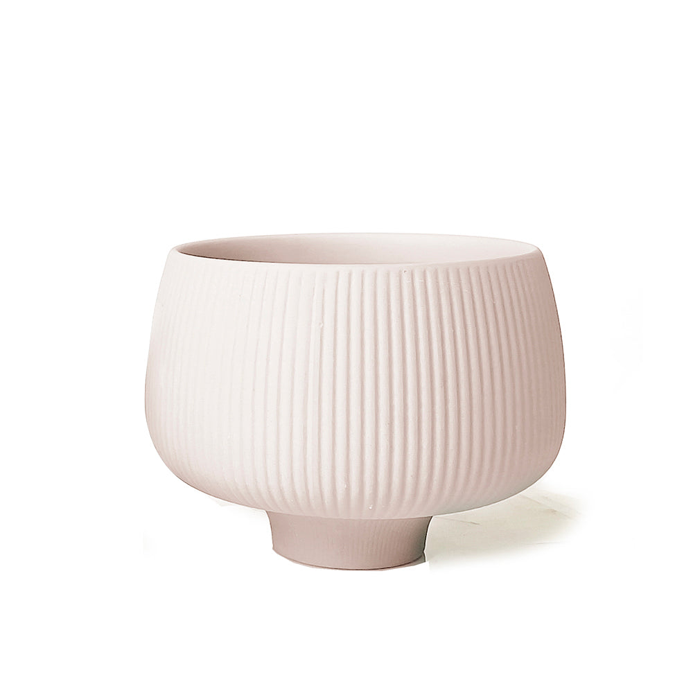 A best-selling Lilo Porcelain Modern Indoor Plant Pot with vertical ribbed texture, sitting on a small footed base against a white background.