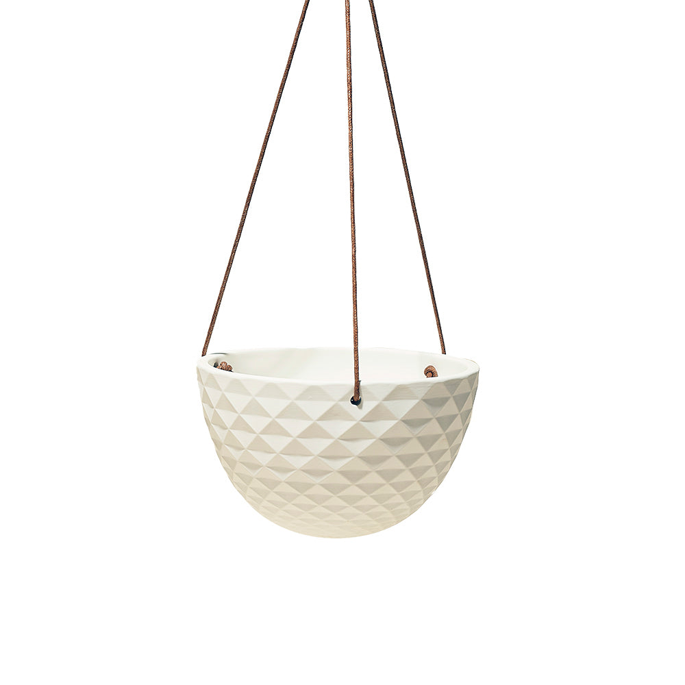 A modern, white, geometric-patterned Mini Mofo Porcelain Modern Hanging planter suspended by three brown leather straps against a plain white background from Chive Studio 2024.