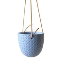 A Virago Ceramic Modern Hanging Planter with a textured exterior, suspended by three brown cords, isolated on a white background, ideal for succulents.